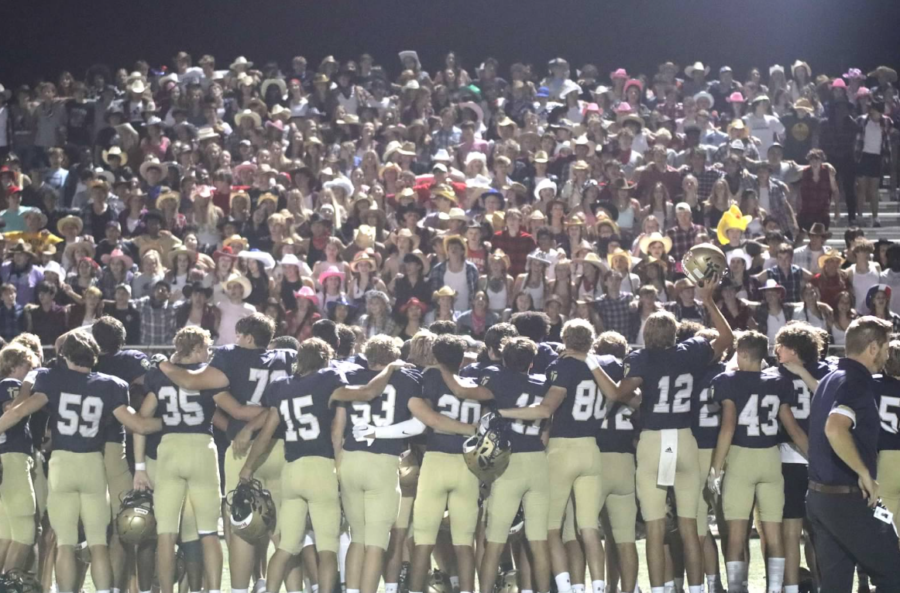 Saints Football celebrate post-game win with the Alma Mater.