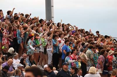 Saint Thomas Aquinas students pack the students in tropical outfits to cheer on their football program.