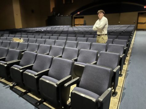 Senior Mathias Glickley standing by the new theater seats.