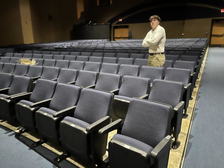 Senior Mathias Glickley standing by the new theater seats.
